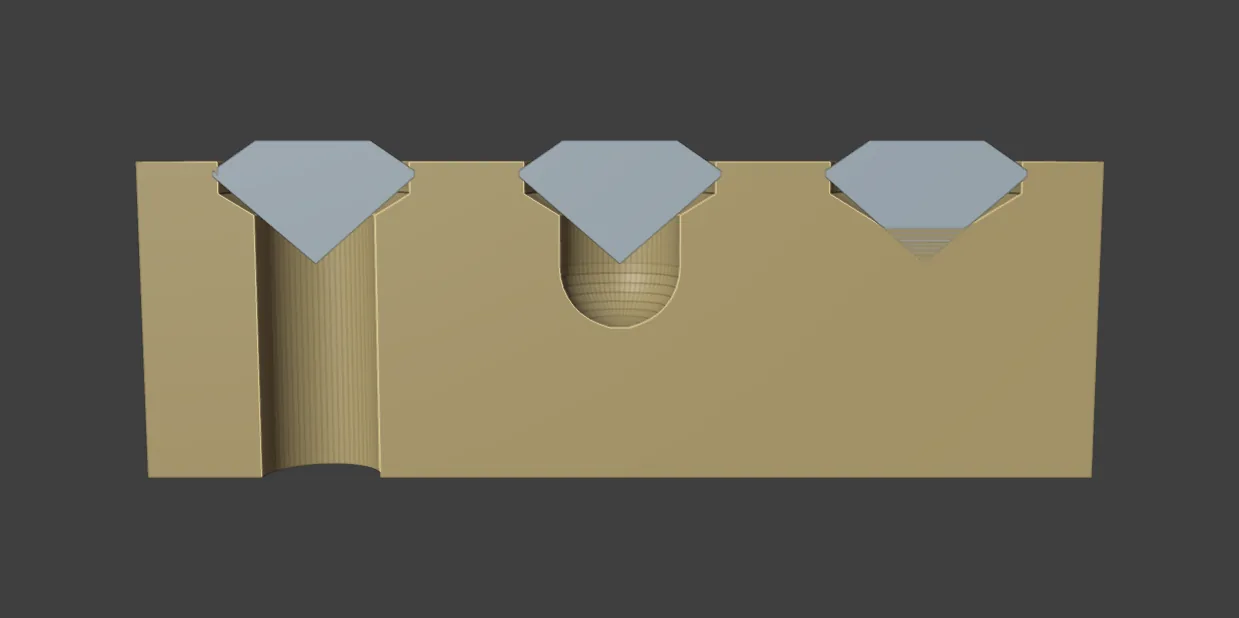 A block cut through the middle showing three seats side by side: a hole through to the back, a round-ended divot and a closed seat, each with its stone in place