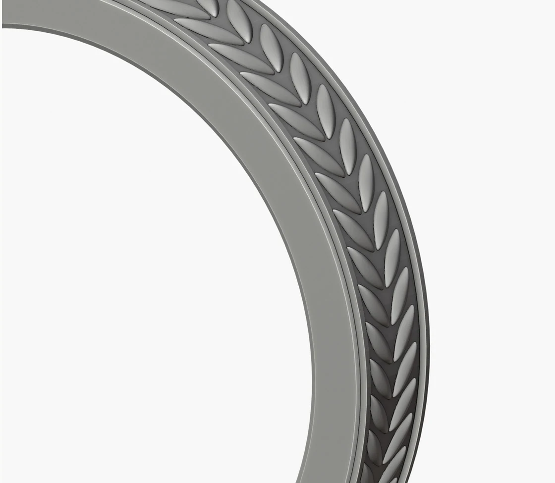 A ring seen close up with the wheat pattern of leaves running round its outer face